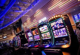 komandan slot app interface showing slot games and sportsbook markets on mobile screen